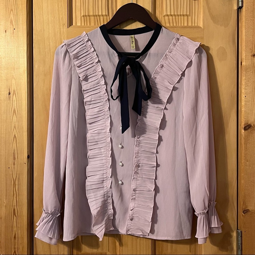 pastel pink ruffled blouse
